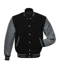 Black varsity jacket with gray leather sleeves, ribbed cuffs, and button front