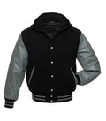 Black and grey hooded varsity jacket front view with snap button closure, letterman style body, and striped ribbed trims.