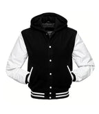 Front view of a black hooded varsity jacket with white leather sleeves, snap-button closure, and striped rib-knit waist and cuffs.