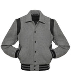 Front view of a heather grey wool varsity jacket featuring a shirt-style collar, black leather shoulder inserts, and black striped ribbed cuffs.